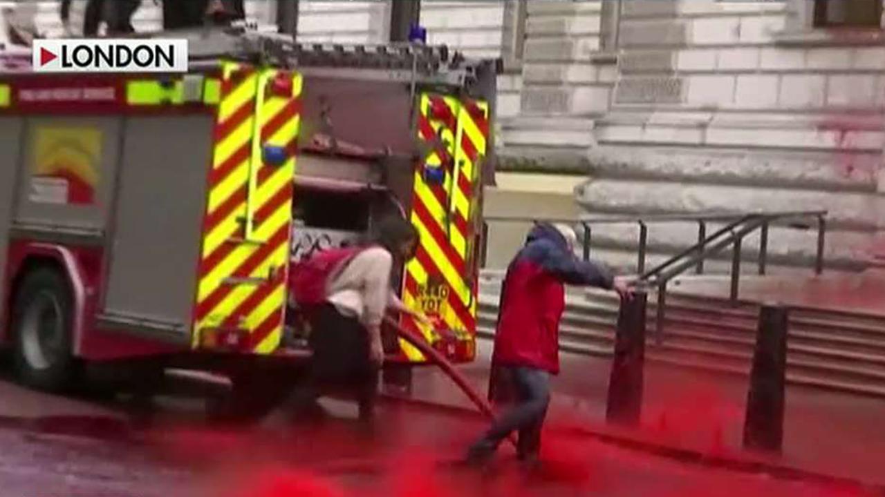Climate activists spray UK's Treasury building with fake blood