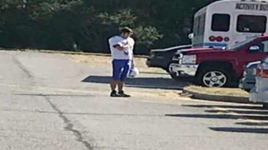High school student stops to salute flag after hearing National Anthem