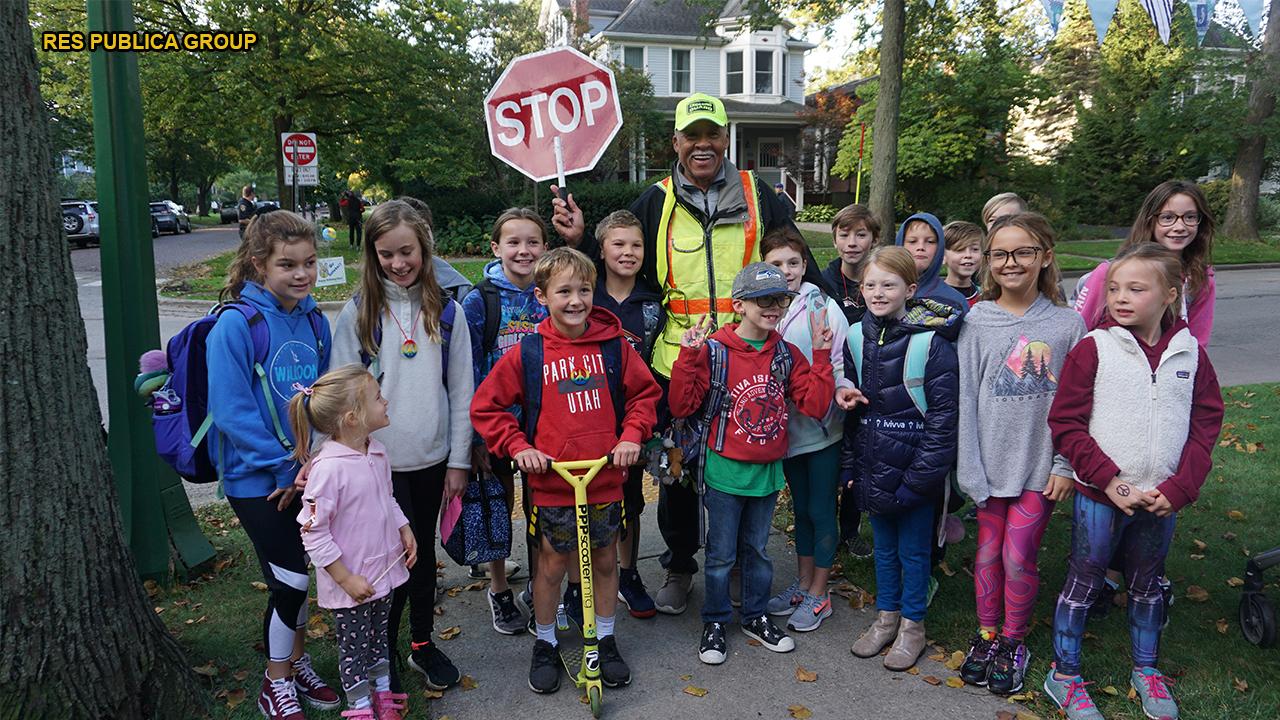 Community surprises beloved crossing guard for 80th birthday