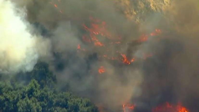 Wind-driven wildfire explodes north of Los Angeles