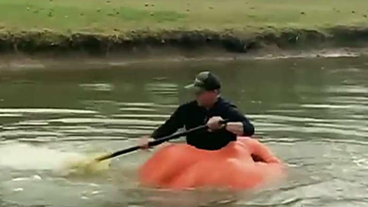 Man uses giant pumpkin as a boat