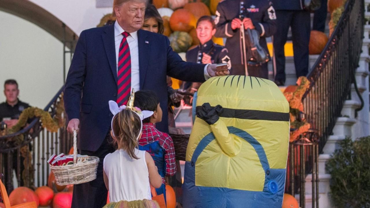 Internet reacts to Trump putting candy on top of child’s Halloween costume