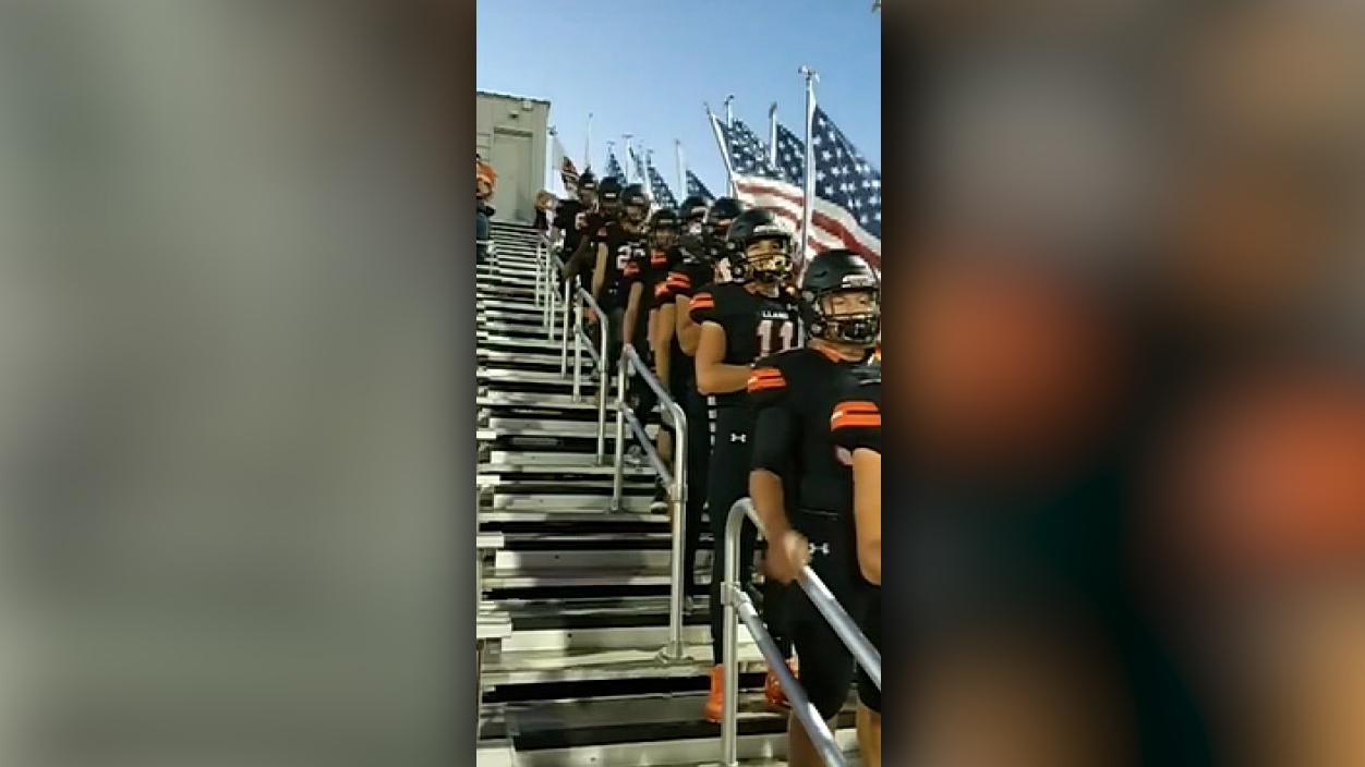 Texas high school football team carry flags to honor military, police officers during game 