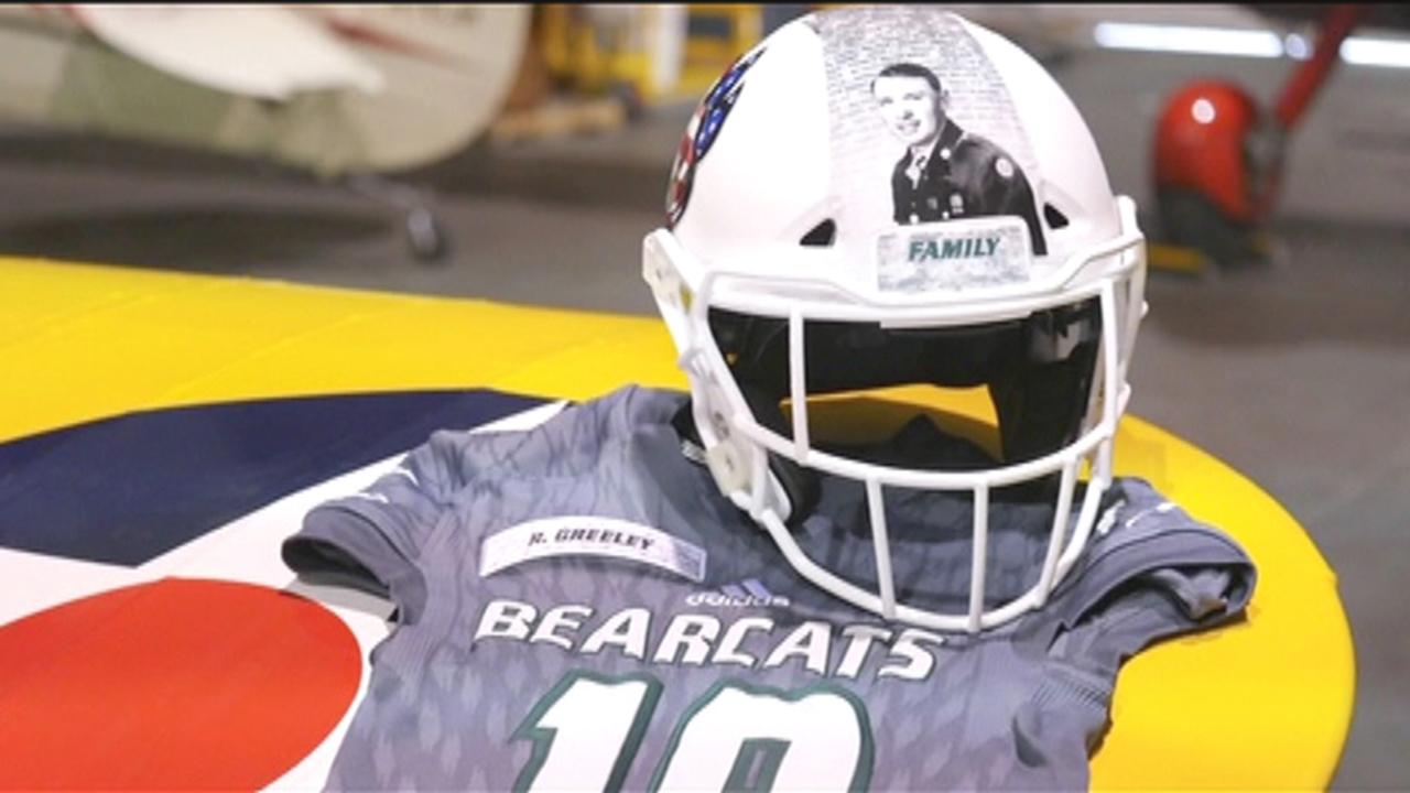College football team wears images of military veterans on helmets