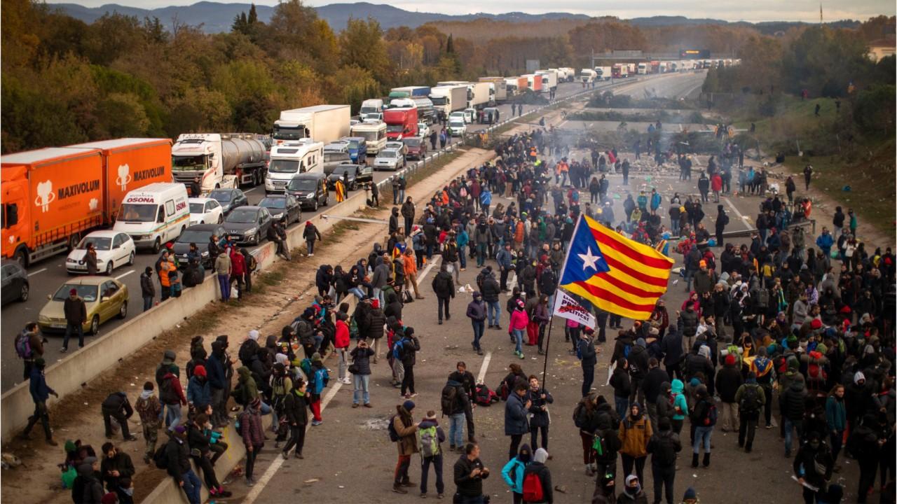 Catalan protesters snarl traffic, burn barricades in major Spain highway