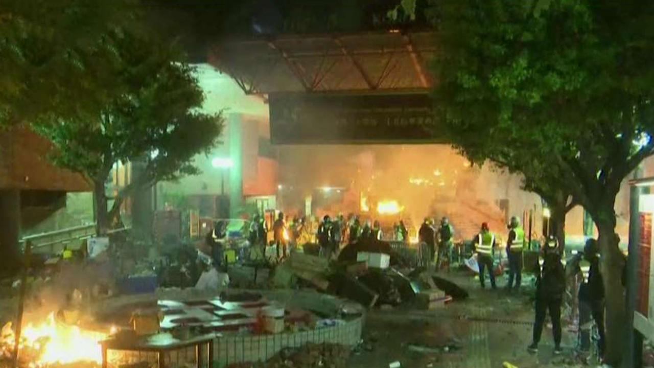 Hong Kong protesters set fire to polytechnic university entrance as police attempt to move in