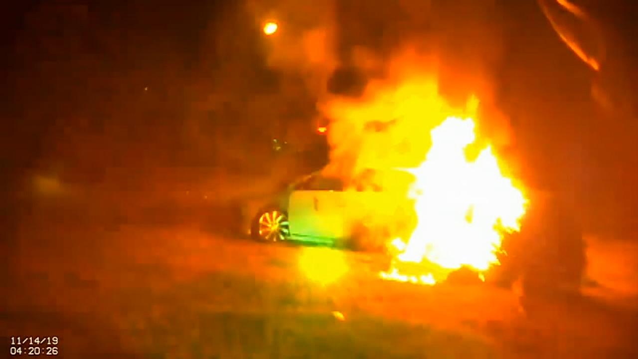 Woman cut out of burning car