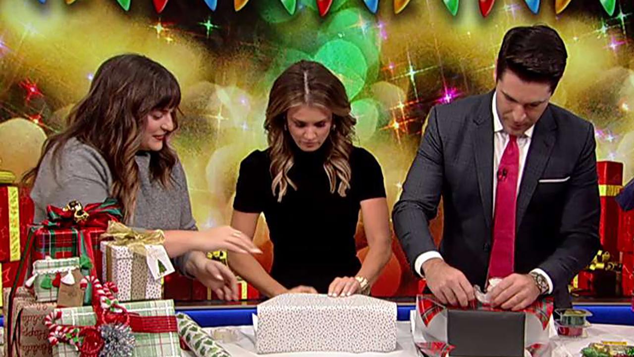 Rob Schmitt and Jillian Mele compete in a holiday wrap battle