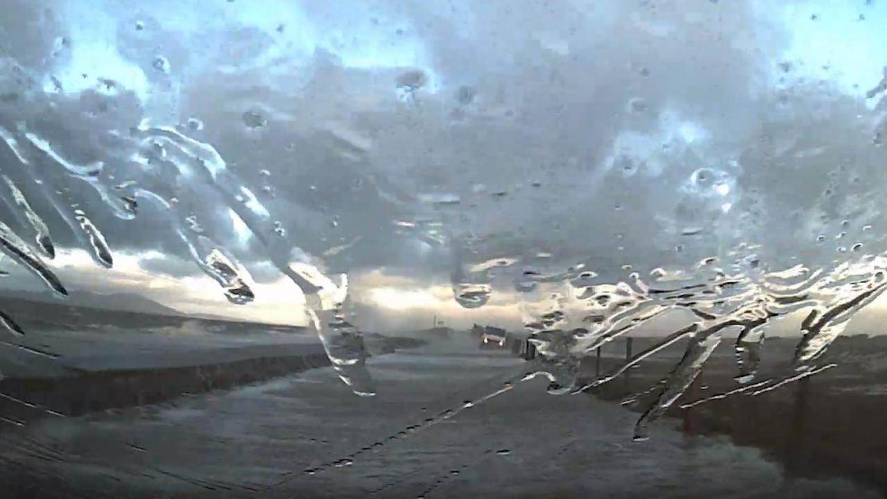 Car slammed by waves escapes flood in dramatic dashcam video