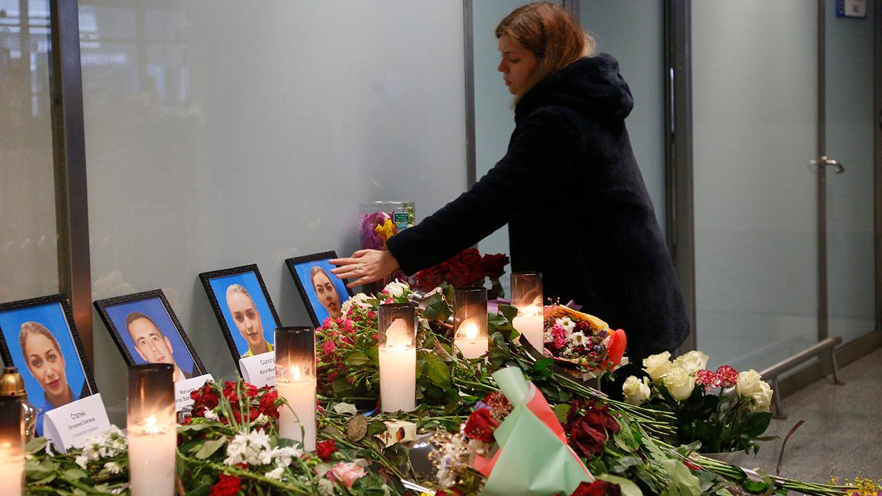 Makeshift memorial in Ukraine pays respect to crew members killed in plane crash