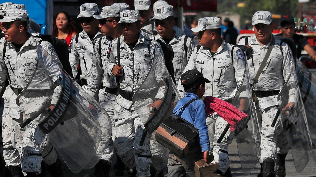 Thousands of Central American migrants stopped by Mexican authorities as they rush border crossing
