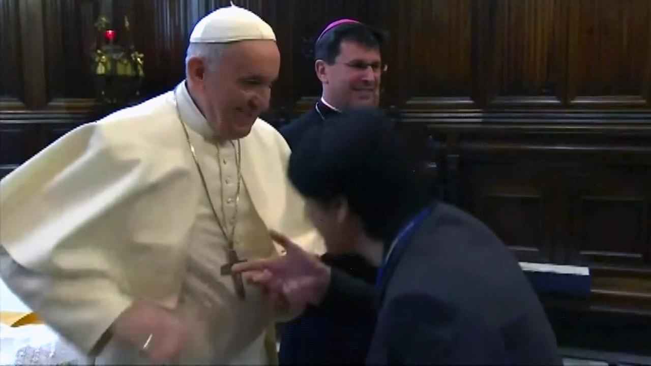 Pope Francis pulls hand away from worshippers wanting to kiss his ring