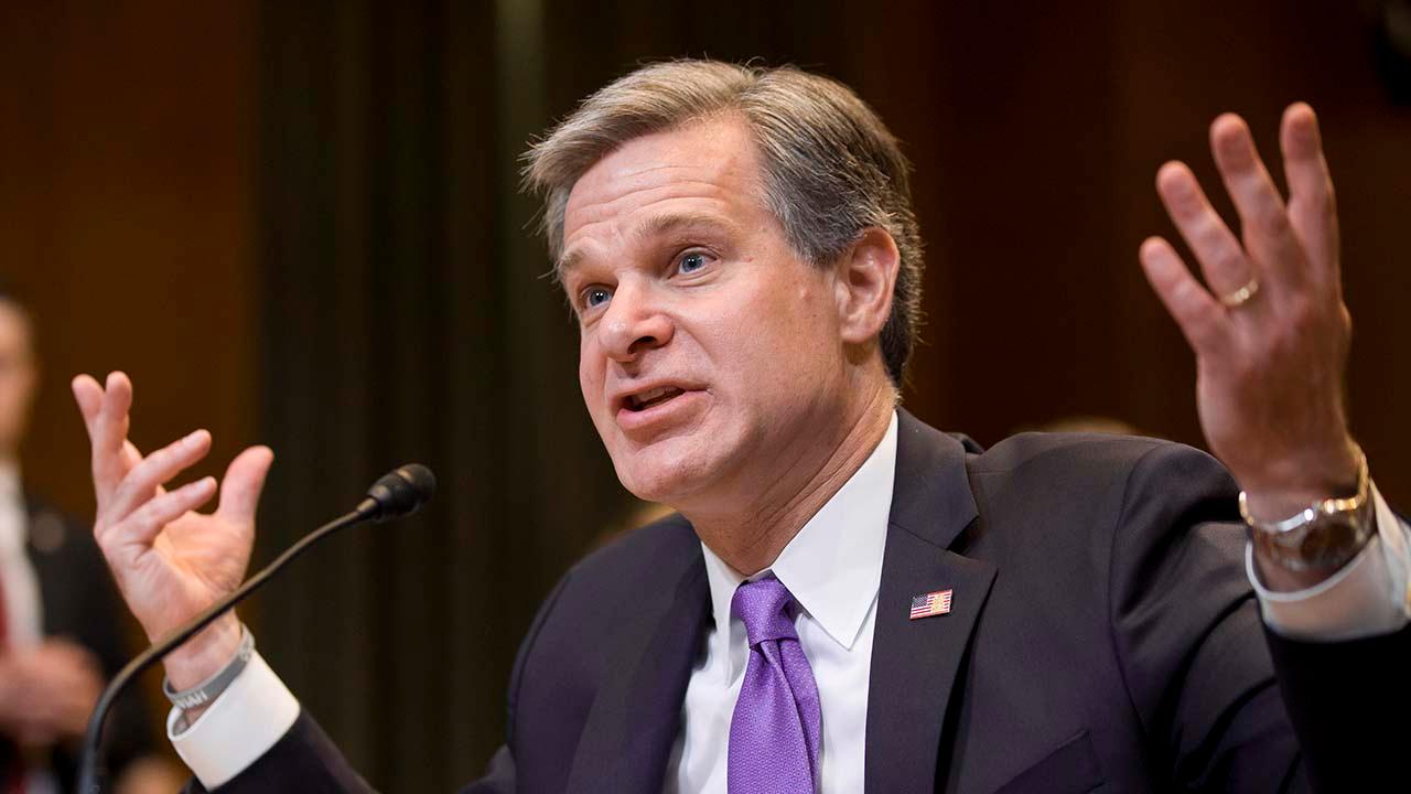FBI Director Wray breaks with Attorney General Barr over whether the government 'spied' on Trump campaign