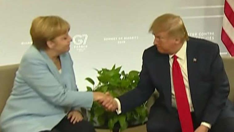 Trump meets with German Chancellor Merkel, strikes bilateral trade deal with Japan at the G7 summit